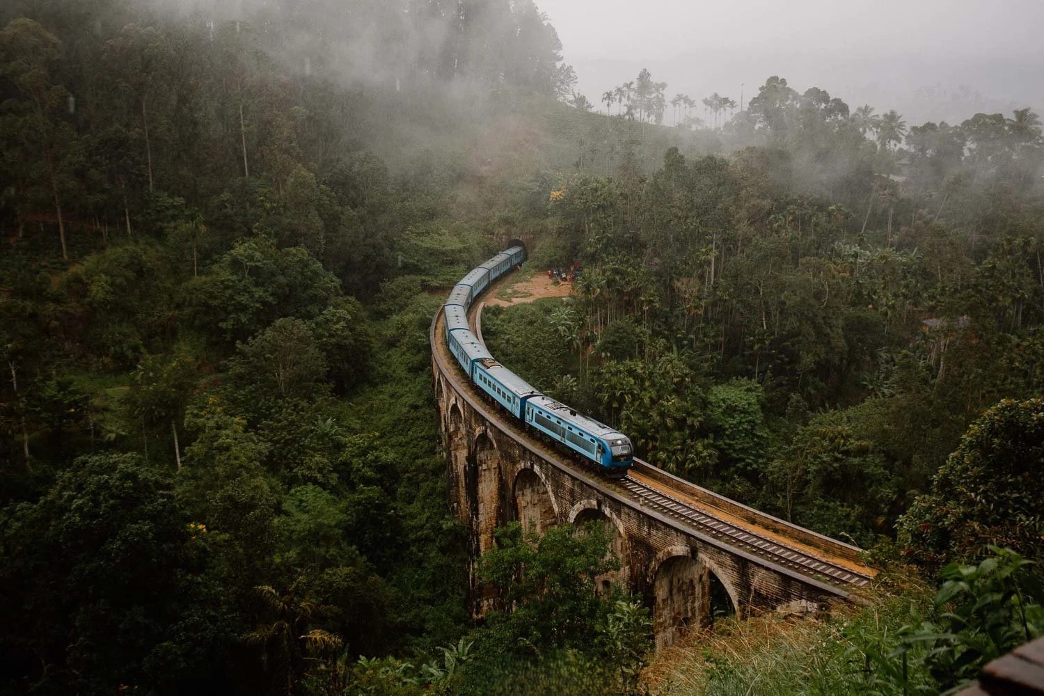 The famous blue train passing through the green tea hills of Ella, Sri Lanka